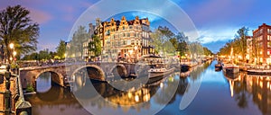 Amsterdam. Panorama of the historic city center of Amsterdam. Traditional houses and bridges of Amsterdam town. A romantic evening