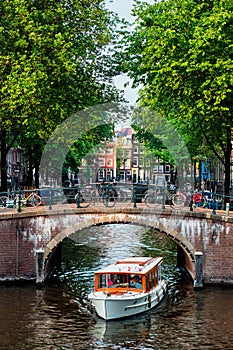 Amsterdam view - canal with boad, bridge and old houses