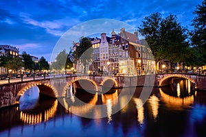 Amterdam canal, bridge and medieval houses in the evening