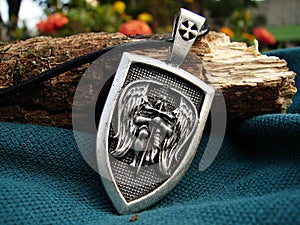 Amulet pendant with protective warrior angel kneeling photo