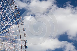 Amusement fun fair ferris wheel against blue sky