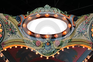 Amusement park carousel floral cresting with lights and mirror