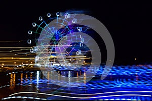 Amusement Park at night - Ferris wheel neon glow in motion