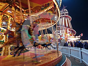 Amusement park ride illuminated at night during the festive season