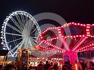 Amusement park ride illuminated at night during the festive season