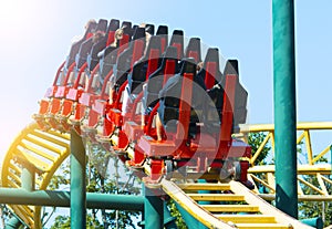 Amusement park. Roller coaster with group of people.