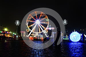 Amusement park. Winter night. Attractions. Bright lights. Carousel in the city. Scenery