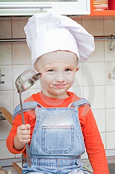 Amusing kid in a cook cap