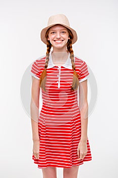 Amusing positive girl with two braids in boonie hat