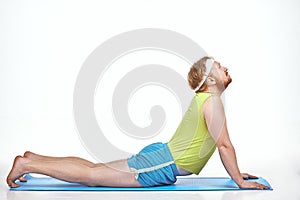 Amusing, red haired, chubby man trains on the mat