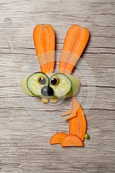 Amusing vegetable rabbit made on wooden board