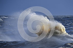 Amzing image of individual wave breaking and cresting during violent windy storm with superb wave detail