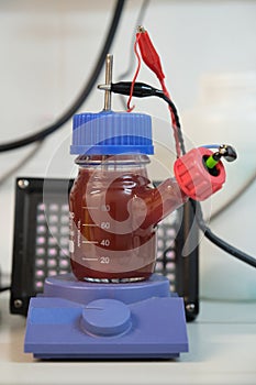 Anaerobic purple and red Photobacteria cultures in a microbial fuel cell, illuminated with infrared illuminators photo