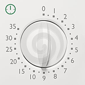 Analog 35 minute microwave oven timer, analogue vintage white dial face macro closeup, grey numbers, green icon, large