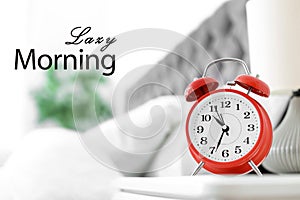 Analog alarm clock in bedroom. Lazy morning