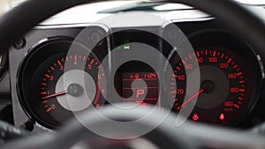 analog car dashboard. Tachometer with speedometer and trip computer in black and red