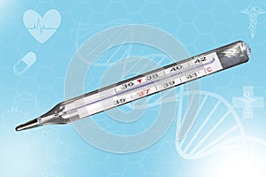 Analog clinical thermometer, mercury free, calibrated in degrees centigrade indicating a temperature of 38.5 degrees centigrade.