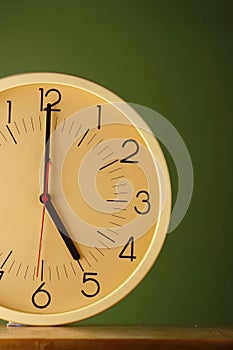 An analog clock at five o'clock position