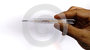 Analog glass thermometer for temperature check holded in hand