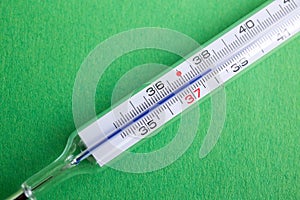 Analog mercury thermometer with 37,7 Â°C of temperature, fever, flu, corona virus, covid19