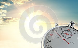 Analog stopwatch against the background of sunrise