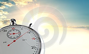 Analog stopwatch against the background of sunrise