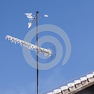 Analog tv antenna covered with snow