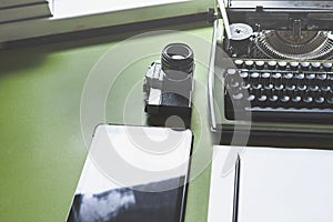 Analog Typewriter, Digital Tablet And Film Camera On The Green T