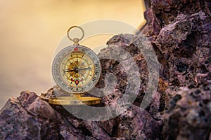 Analogical compass abandoned on the rocks