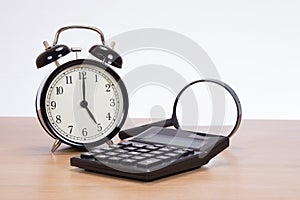 Analogue clock, calculator and magnifying glass