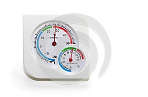 Analogue home thermometer and hygrometer in a white background