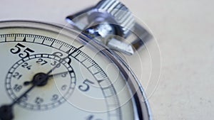 Analogue metal stopwatch on white table background