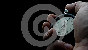 Analogue stopwatch in man hand