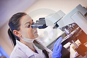 Analyse, laboratory and woman scientist by microscope for research or medical breakthrough. Data, female technician and photo