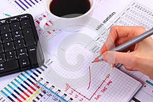 Analysis of sales plan, computer keyboard and cup of coffee, business concept