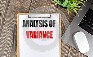 ANALYSIS OF VARIANCE text on clipboard paper with laptop, mouse and pen photo