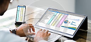 Analyst Employee Using Spreadsheet Software On Phone