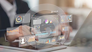 An analyst uses a computer and dashboard for data business analysis and a Data Management System with KPI and metrics connected to