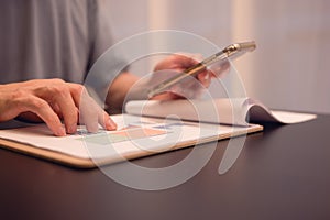 An analyst uses smartphone and a dashboard for data business analysis and Data Management System