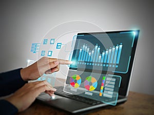 Analyst working with Business Analytics and Data Management System on computer, making report with KPI and metrics connected to