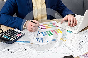Analyzing business graphs in office by businessman.