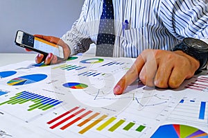 Analyzing income charts and graphs with calculator. Close up.Business financial analysis and strategy concept.