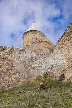 Ananuri Fortress complex in Georgia on the Georgian military road, blue sky and blooming trees