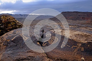 Anasazi petroglyphs in front of desert mountains