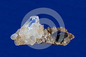 Anatase Crystal, Quartz crystals on host rock. Blue Background.