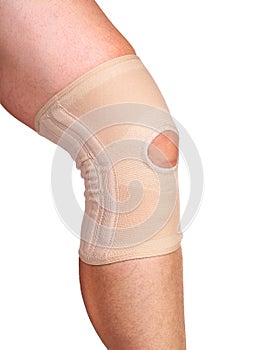 Anatomic knee joint orthosis on leg. Elastic compression bandage photo