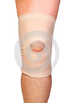 Anatomic knee joint orthosis on leg. Elastic compression bandage