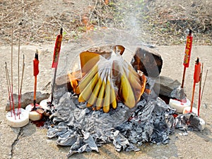 Ancestor offering burning at grave site