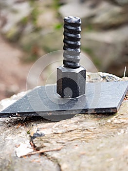 Anchor bolt in the granite stone, protecting the bridge