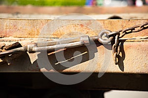 Anchor bolt holds a rusty chain taut